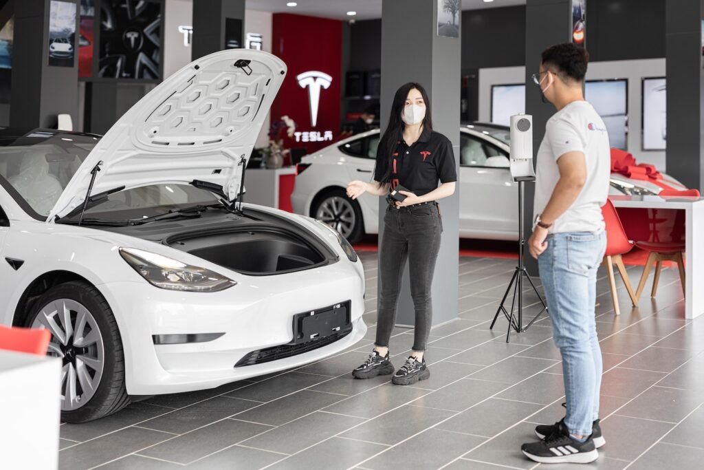 A Person Looking at a Tesla Model 3 at a Car Dealership